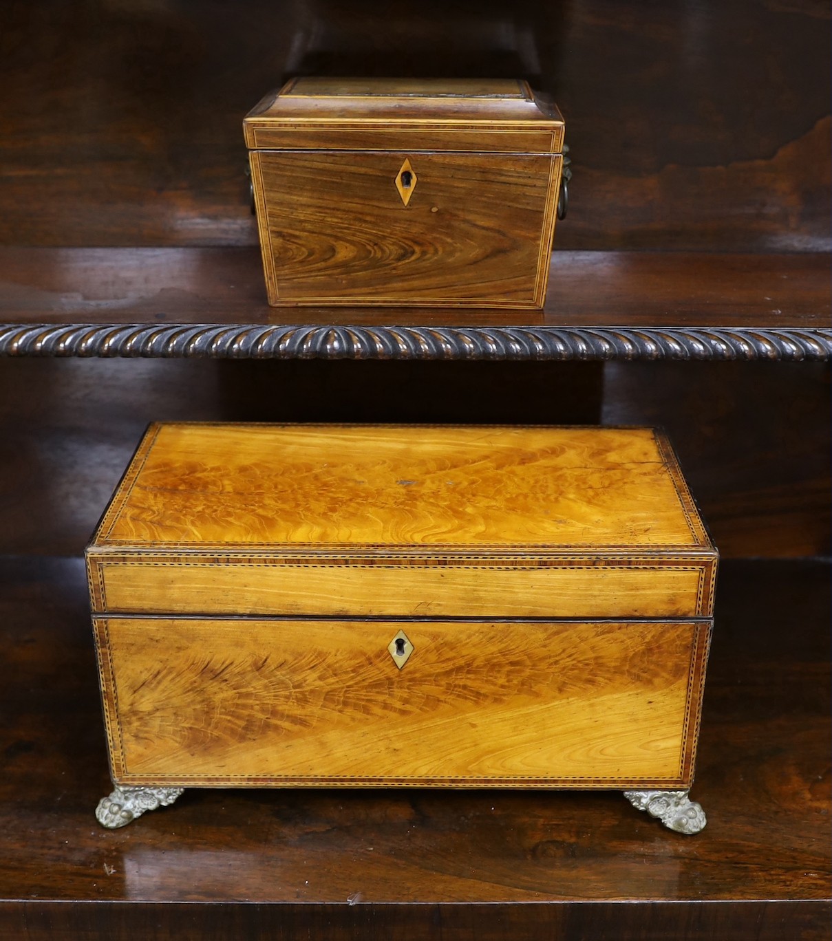 A Victorian flame-veneered tea caddy and another, smaller